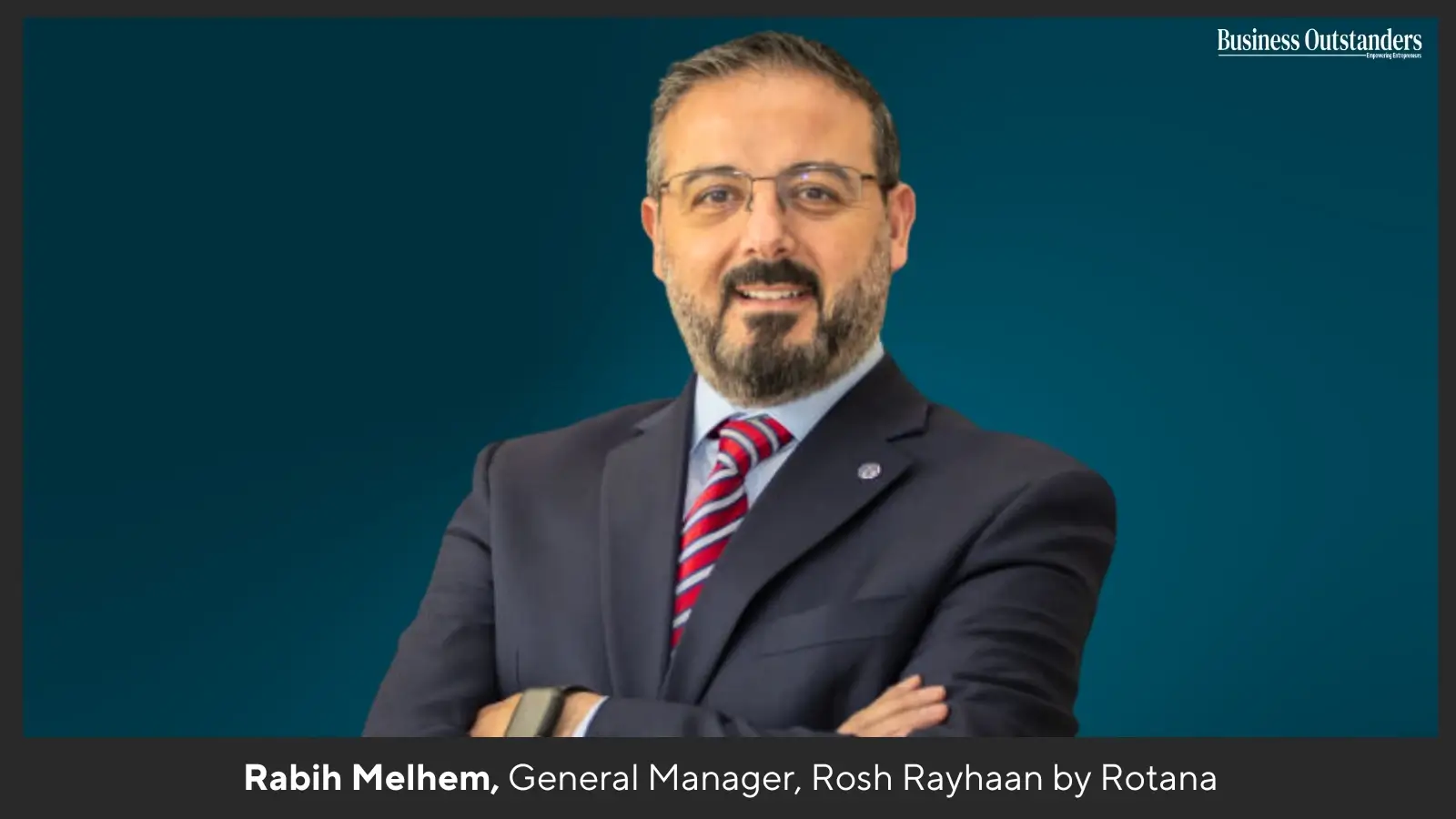 Rabih Melhem standing in a luxury hotel lobby, showcasing leadership in hospitality