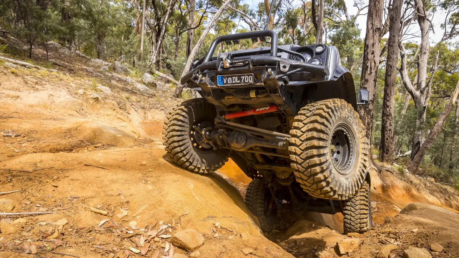 4x4 vehicle driving through rugged Australian terrain