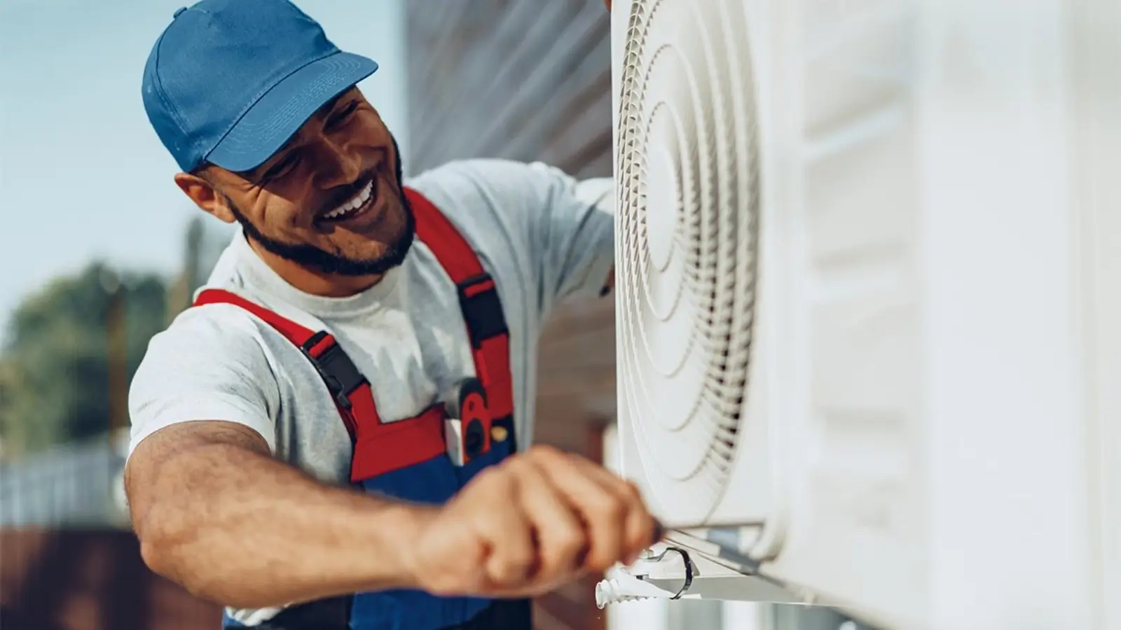 A technician servicing an HVAC unit in a residential home