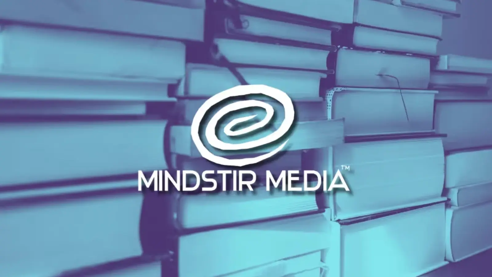 Author holding a newly published book with MindStir Media logo in the background