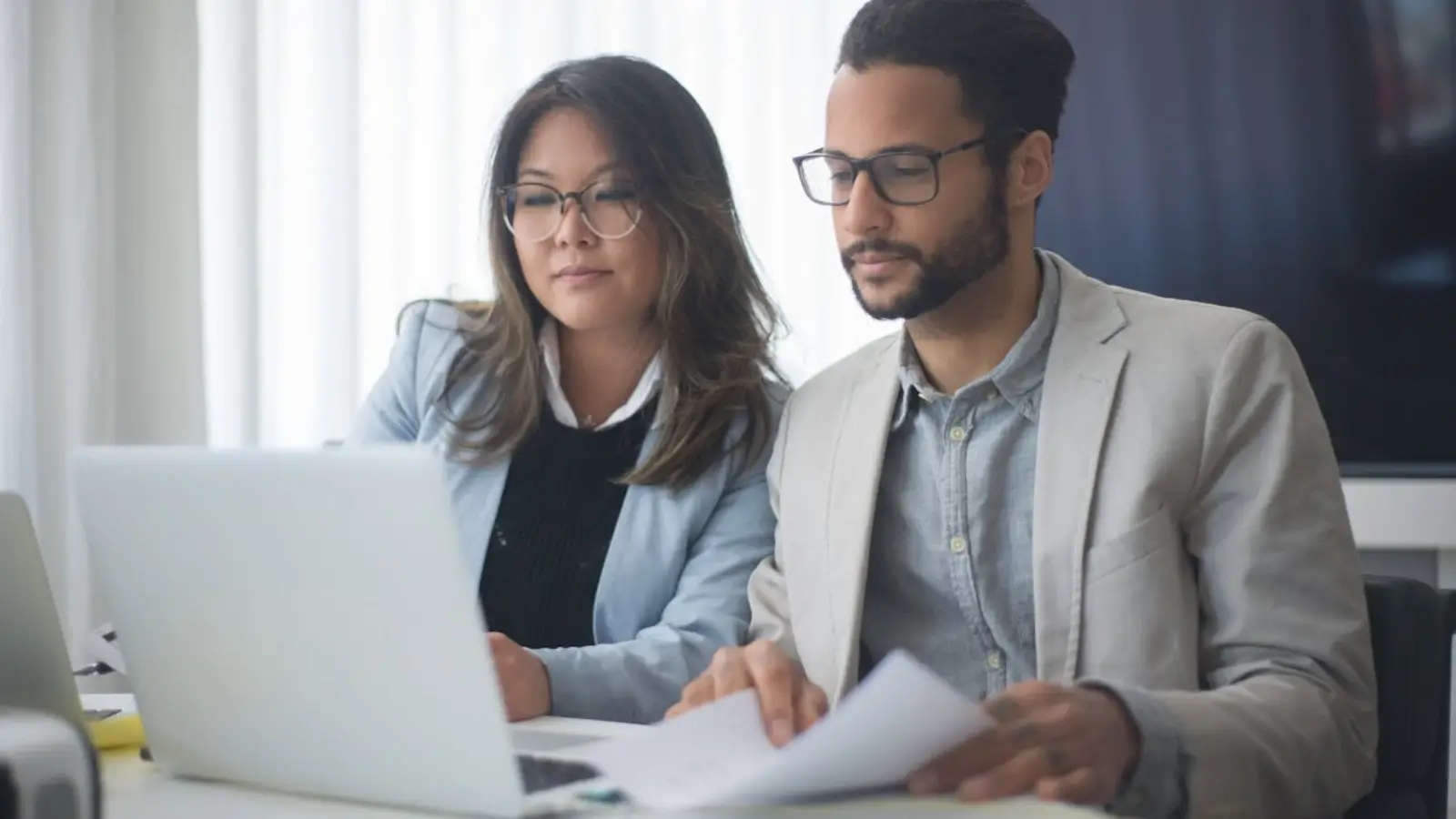 Business team using address validation tool on laptop for customer data accuracy