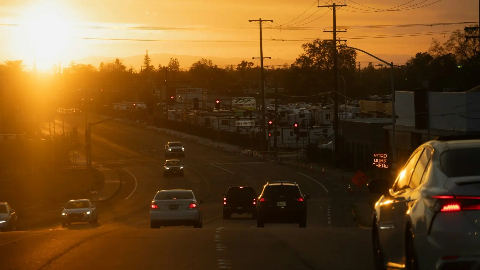 Car driving on a Tempe, Arizona street during sunset with traffic and city skyline