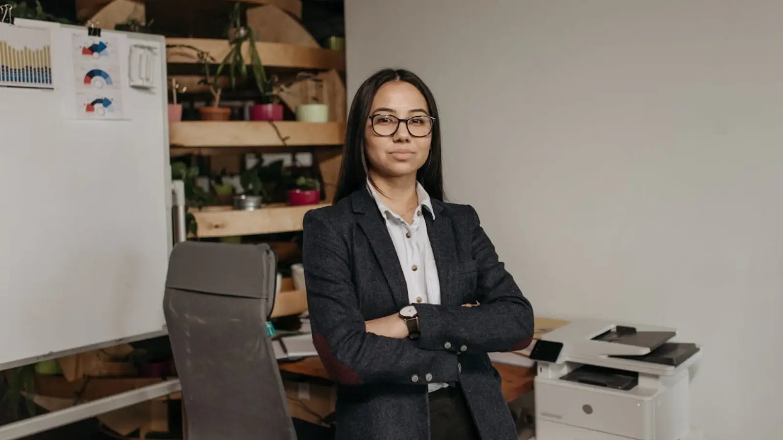 4 Tips To Help You Become A More Effective Leader Confident business leader presenting to team in a modern office setting