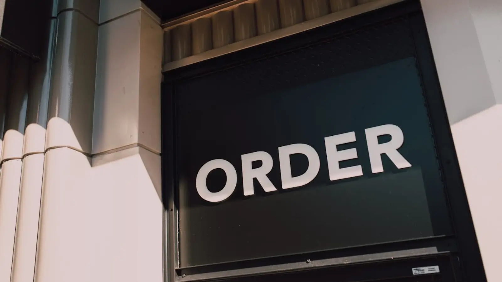 Boost Your Brand Appeal with Creative Metal Signage Solutions Custom creative metal business sign mounted on a modern commercial building exterior