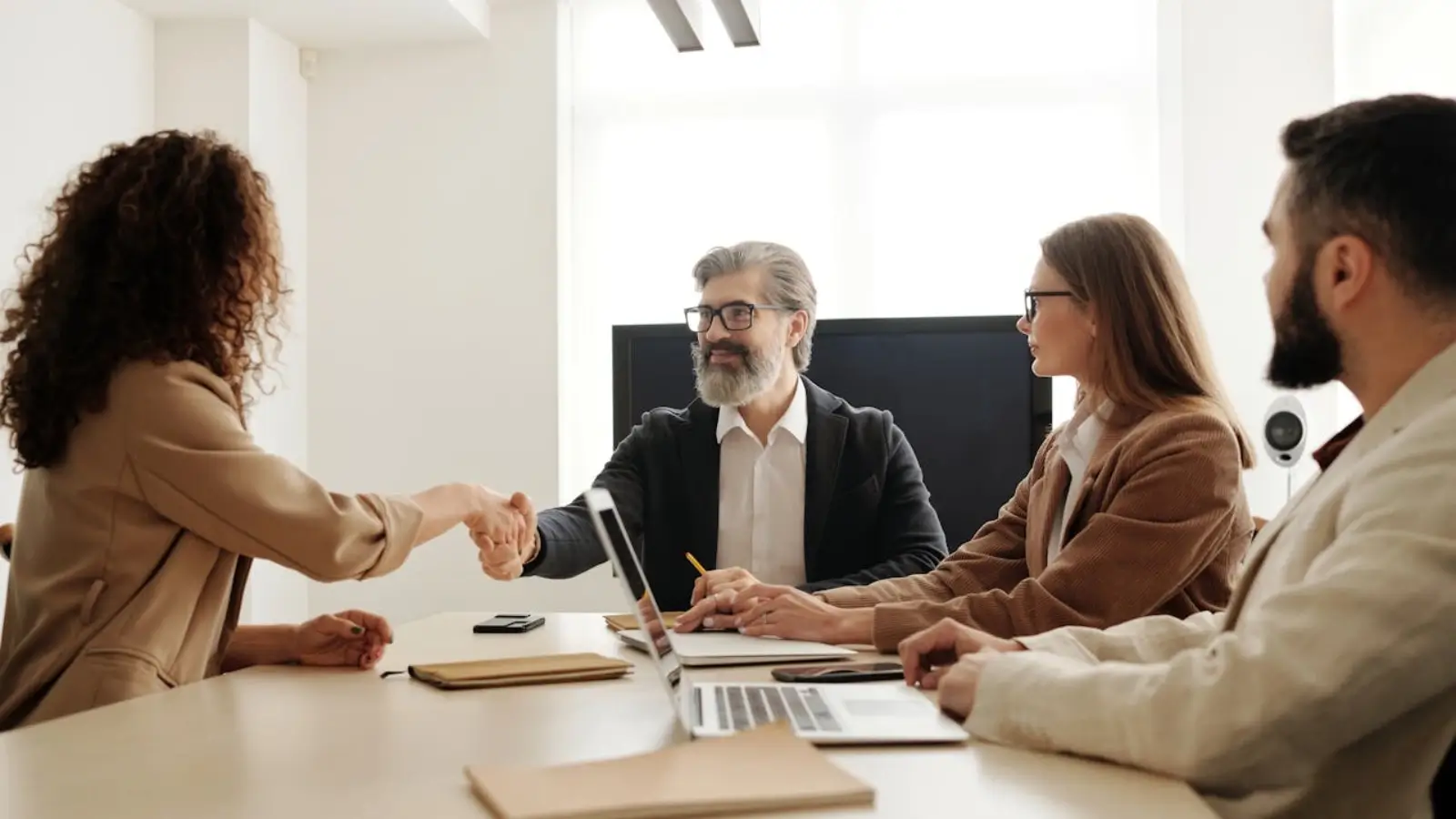 Employees discussing group benefits with an insurance consultant in an office setting