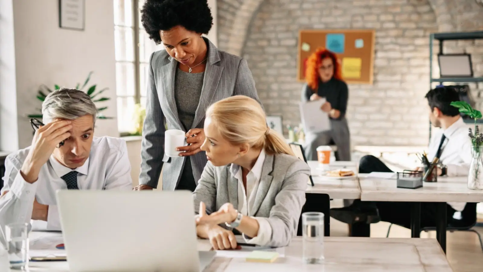 Frustrated business team dealing with outdated computers and slow network issues