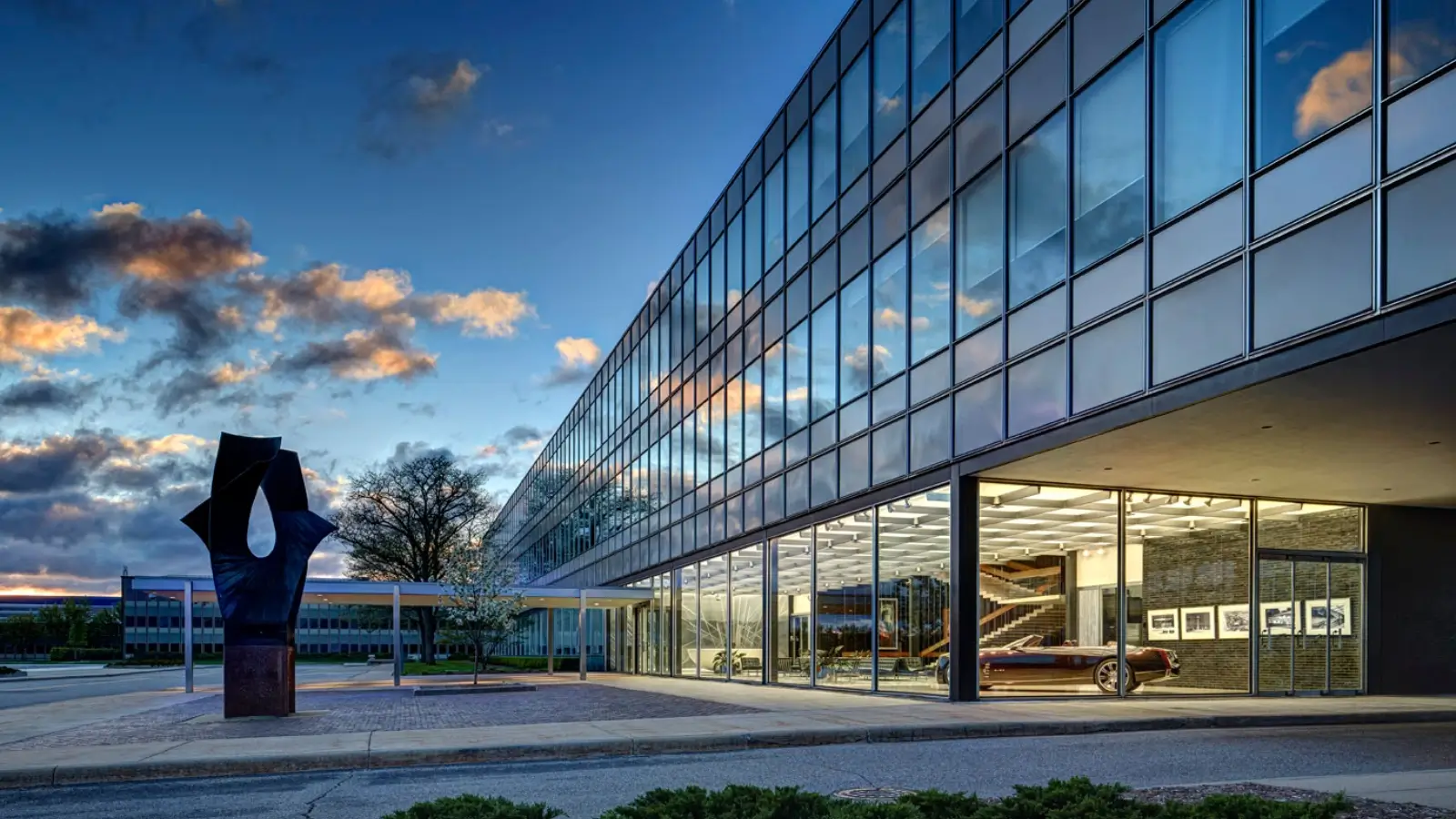 General Motors Revamps Engineering Team as Earning Surge General Motors Warren Michigan facility with GM logo and employees walking outside