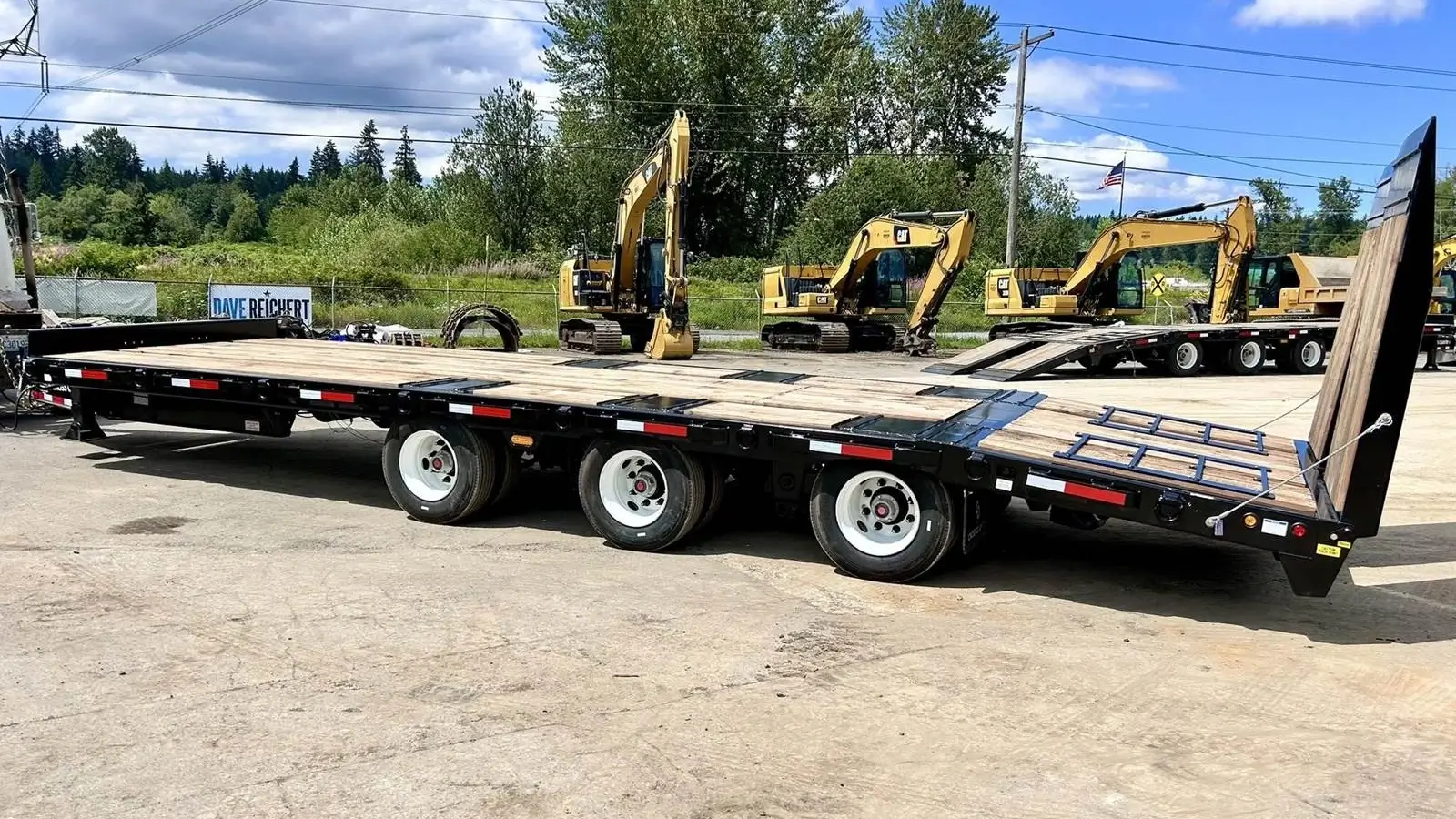 Heavy-duty tag along trailer hitched to a truck at a job site