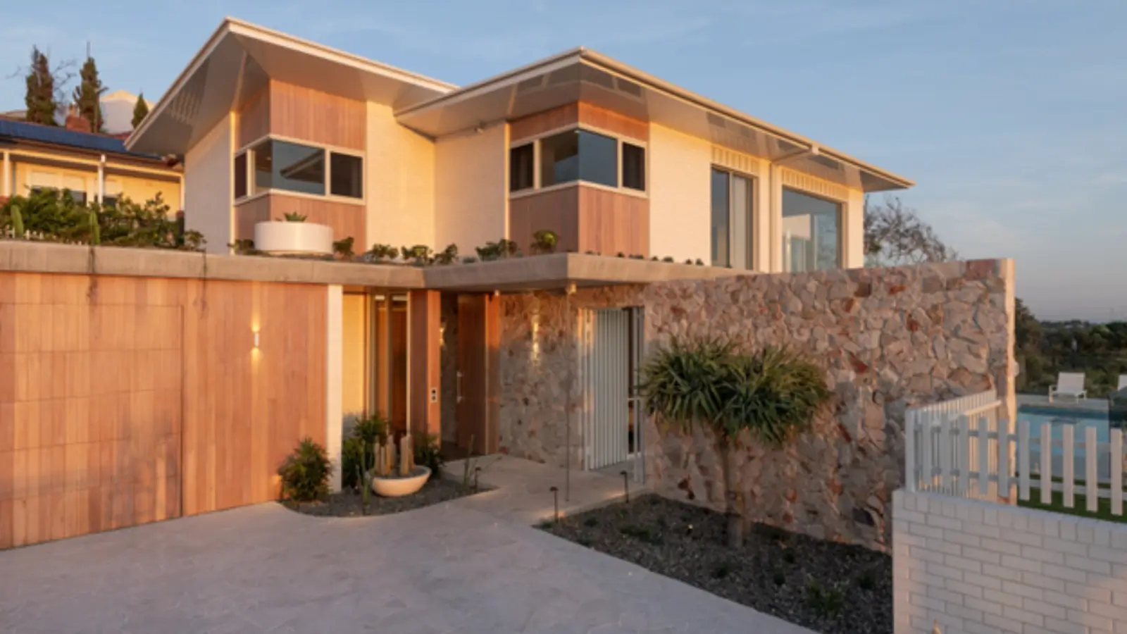 Luxury home under construction with scaffolding and workers on site