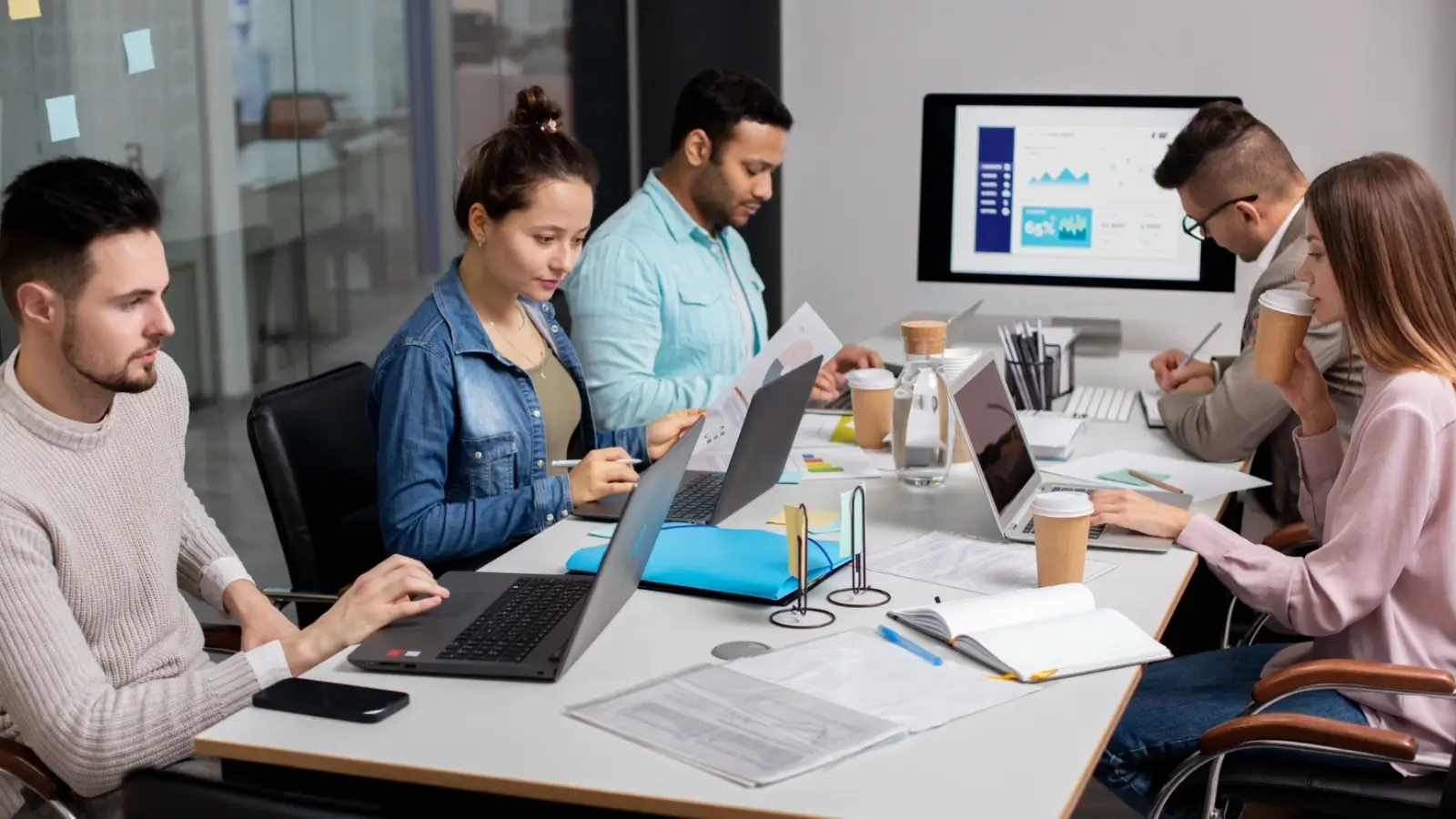 5 Major Advantages of Outsourced Media Consultancy Media consultants collaborating on communication strategy in a modern office environment