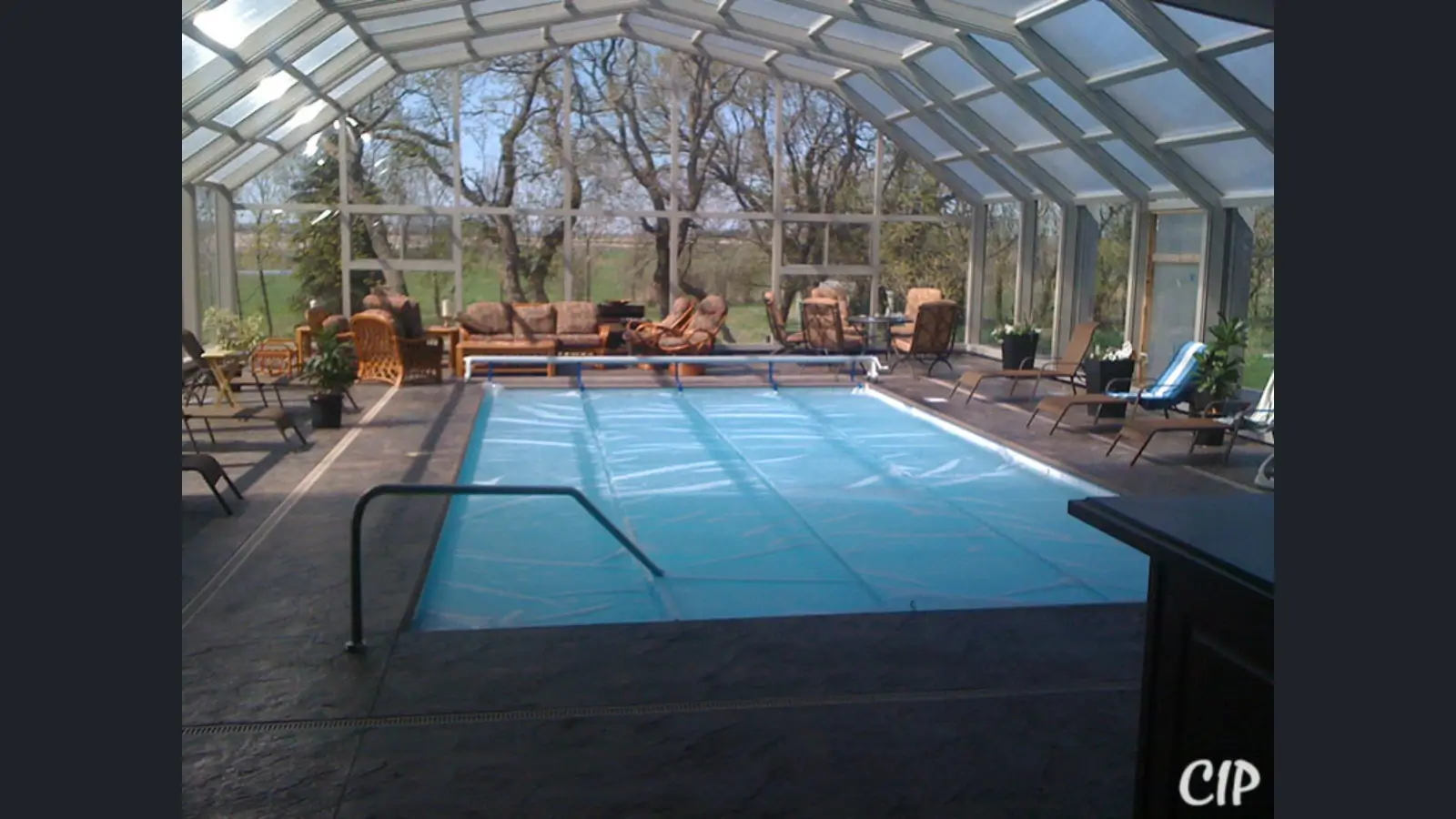 Modern backyard pool with retractable enclosure for year-round use