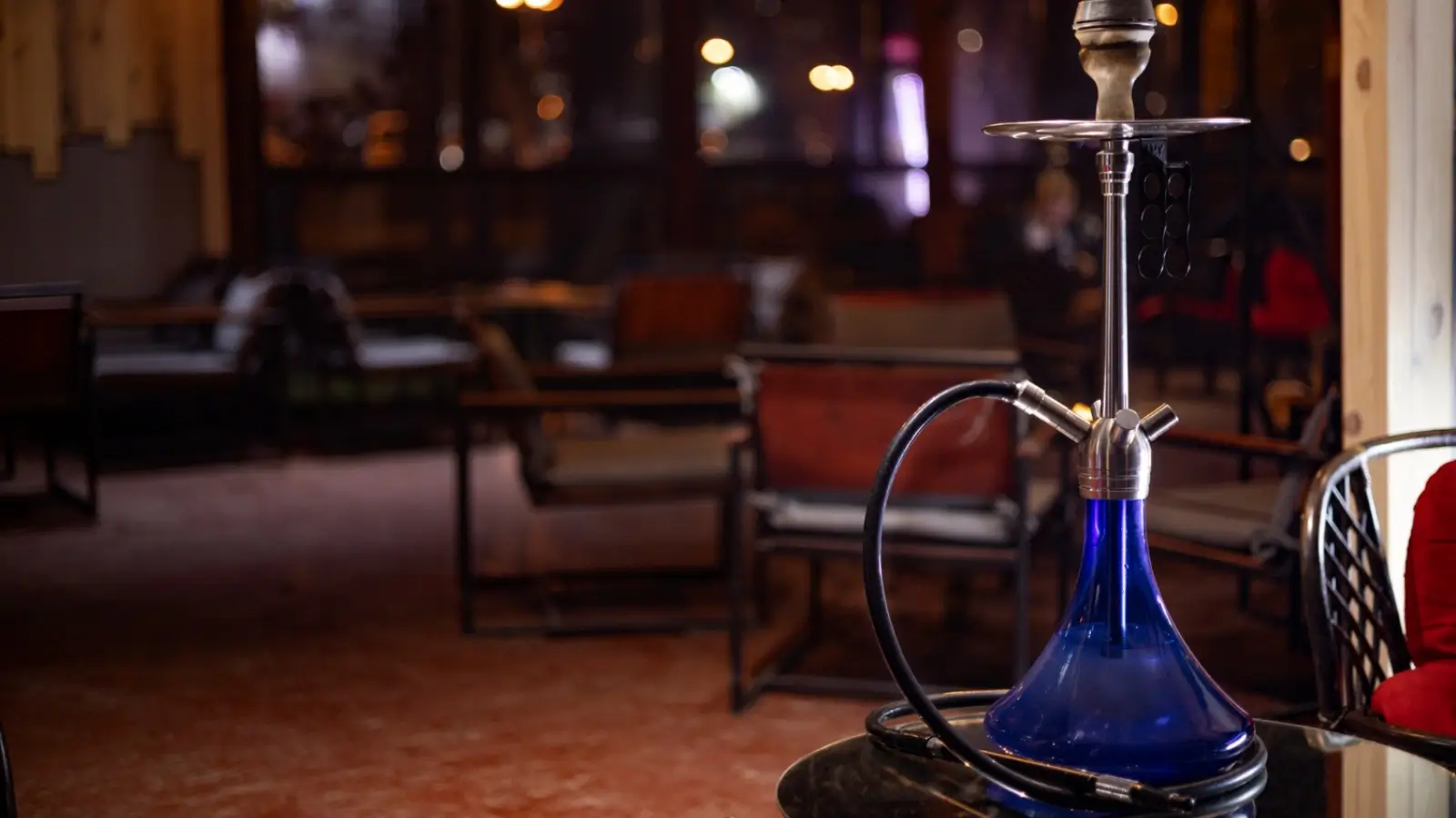The Modern Hookah Renaissance: How Culture, Craft, and Community Inspire a New Generation of Entrepreneurs Modern glass hookah setup on a lounge table with ambient lighting