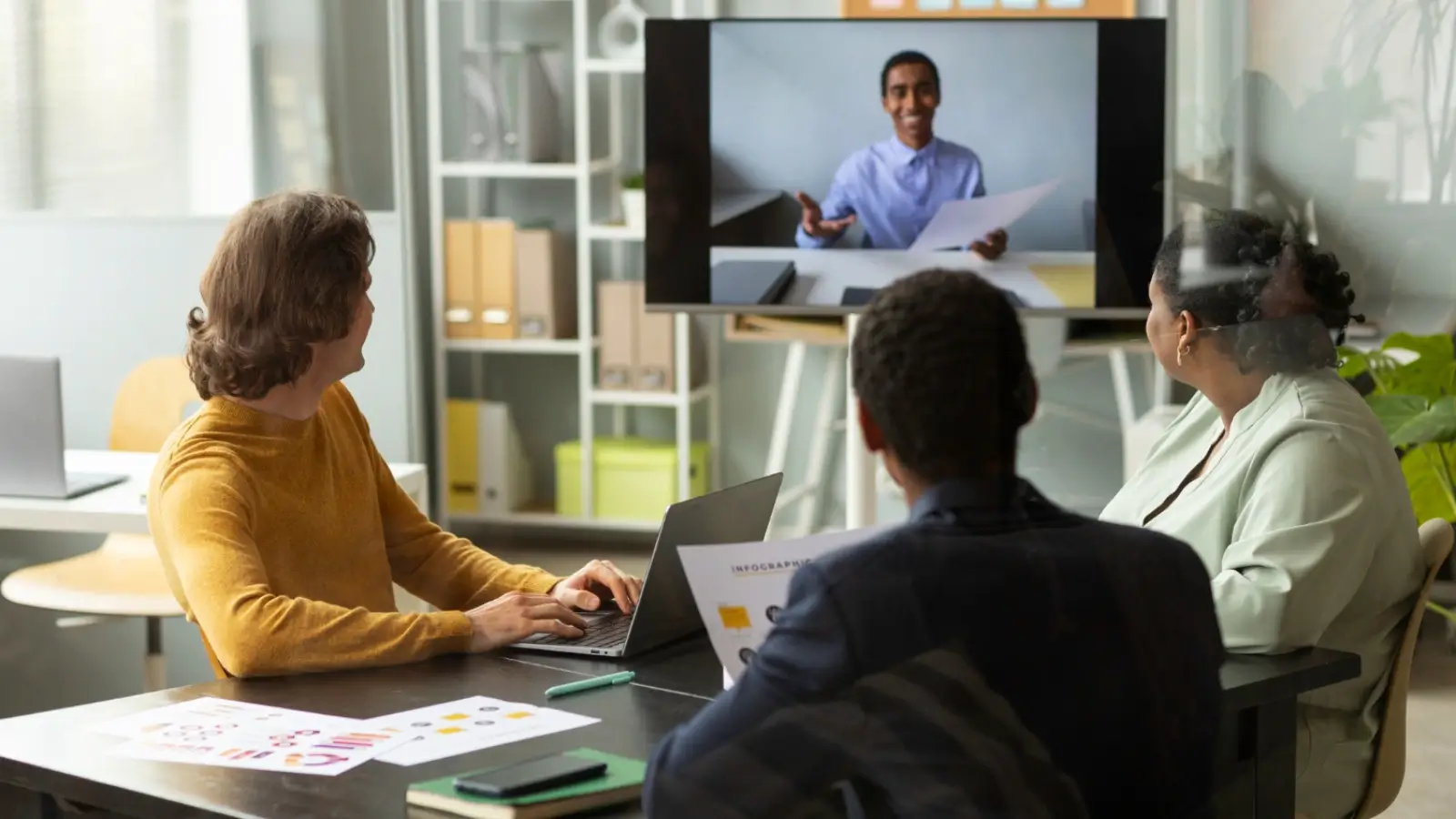 Key Changes to HR Departments in the UK To Look Out For Next Year Modern HR team collaborating with digital tools in a hybrid work environment
