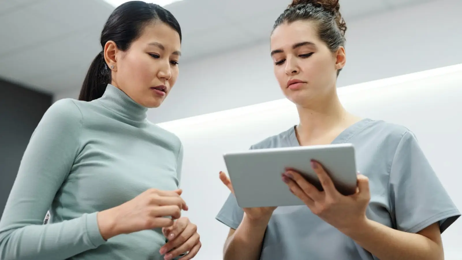Patient using a digital healthcare platform on a tablet with doctor profile and secure login visible