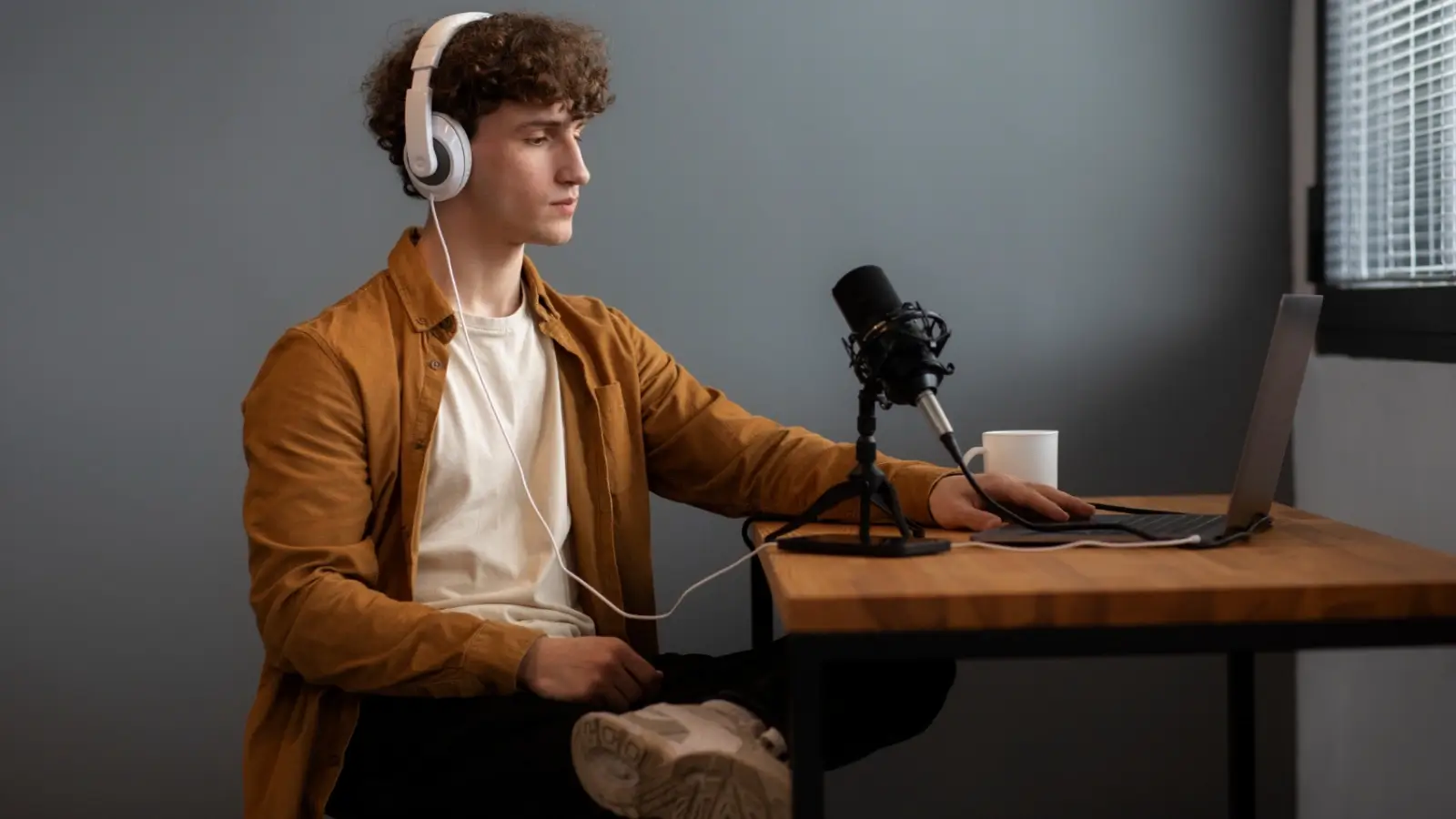 Podcaster using AI tools to edit and personalize a podcast episode in a studio