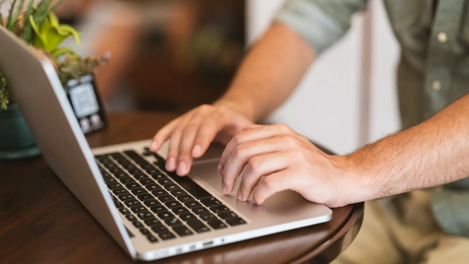 Downloading Web Video Content for Presentations and Team Training Professional downloading a training video on a laptop for an offline team presentation