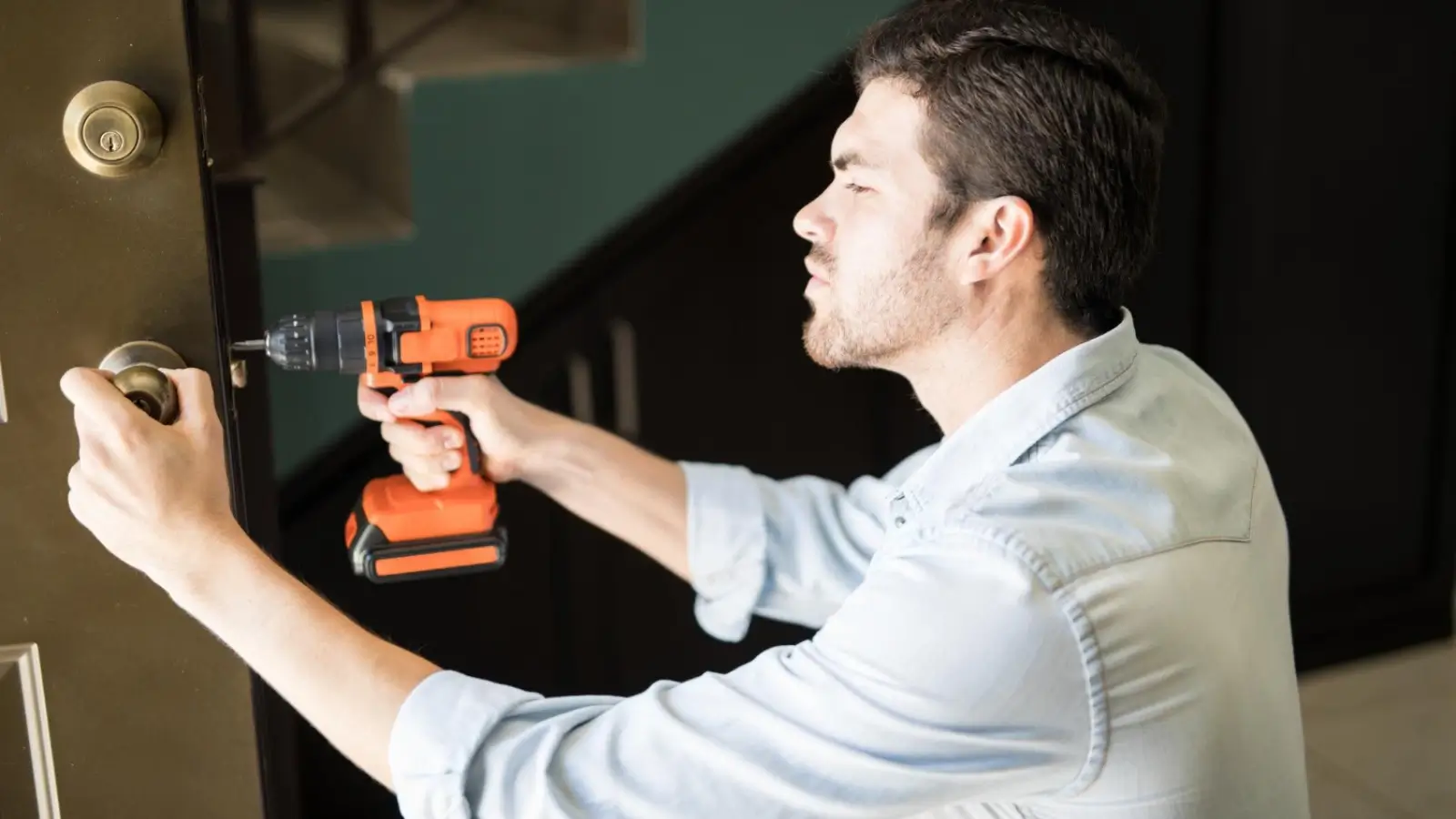 Professional locksmith cutting a key in a Cardiff workshop