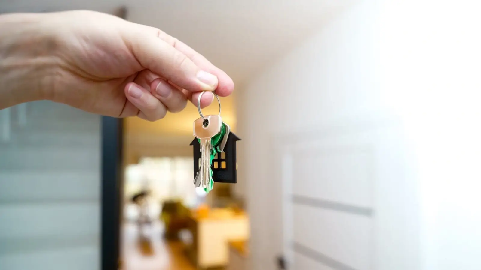 All-Cash Buyers Tighten Grip on the U.S. Housing Market in 2025 Real estate agent handing house keys to a cash buyer outside a sold home