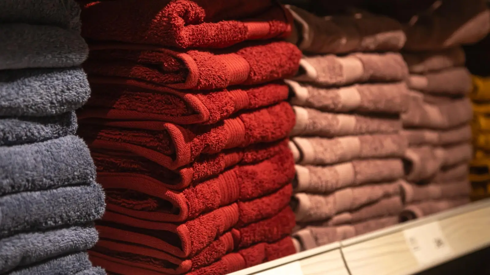 Top 5 Bulk Towel Brands That Combine Quality and Affordability Stack of assorted bulk towels in various colors and sizes for commercial and home use