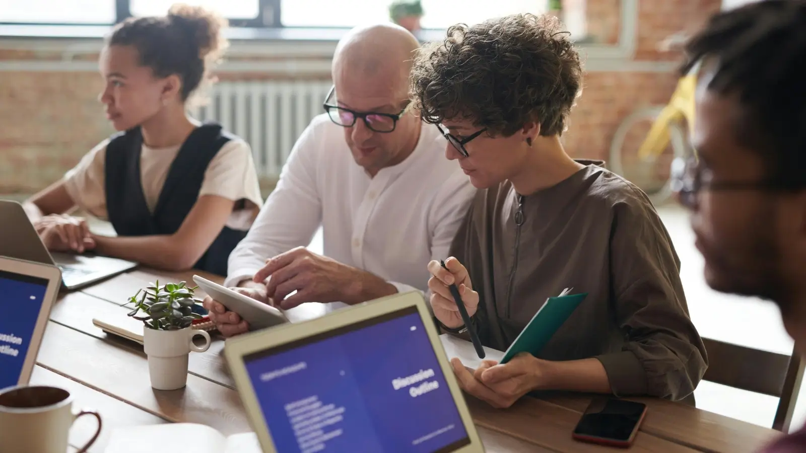 Compliance Mistakes to Avoid in Your Communication Systems Team analyzing business communication compliance on digital dashboard
