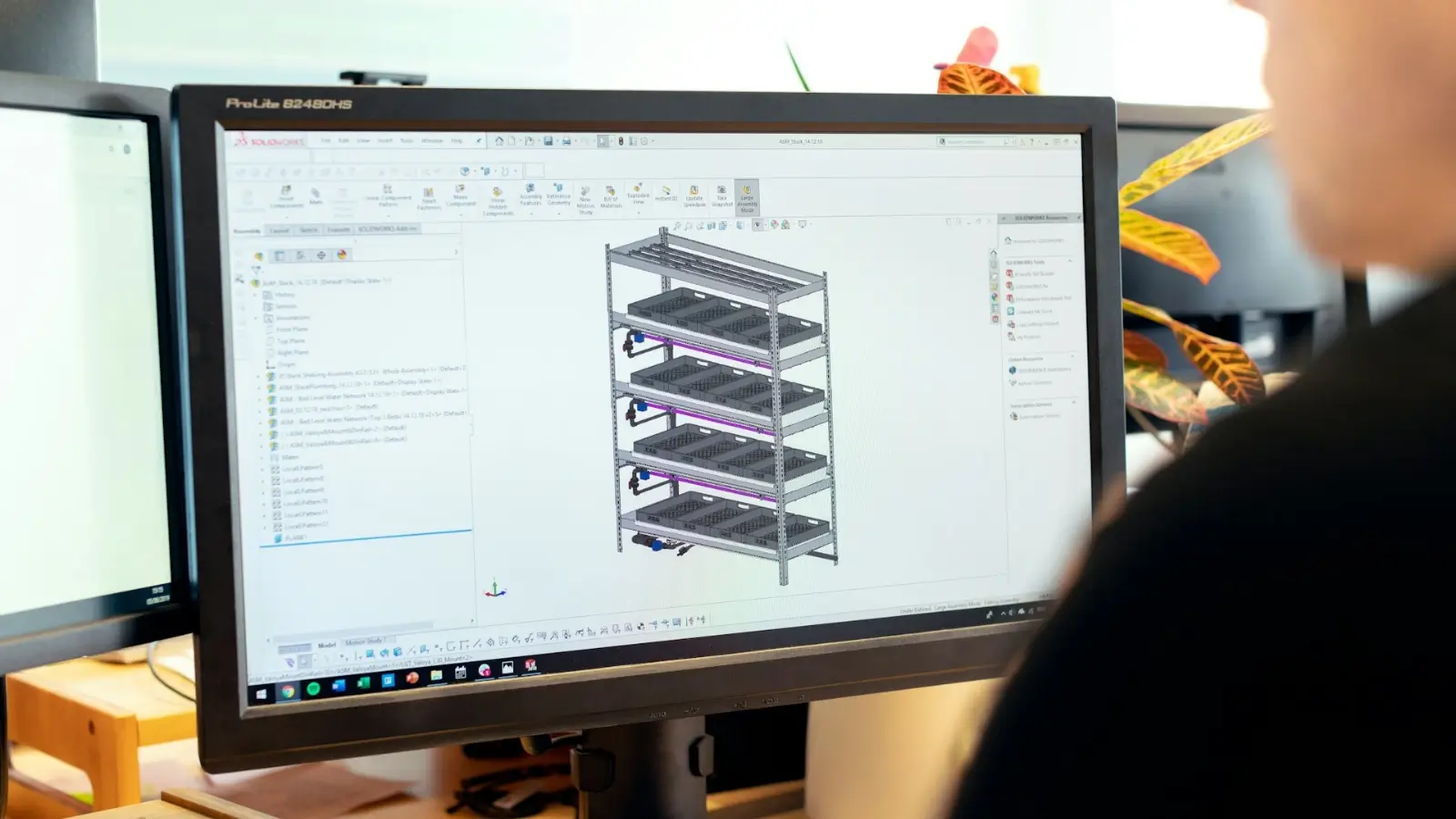 Team collaborating on product development with design sketches and a prototype on the table