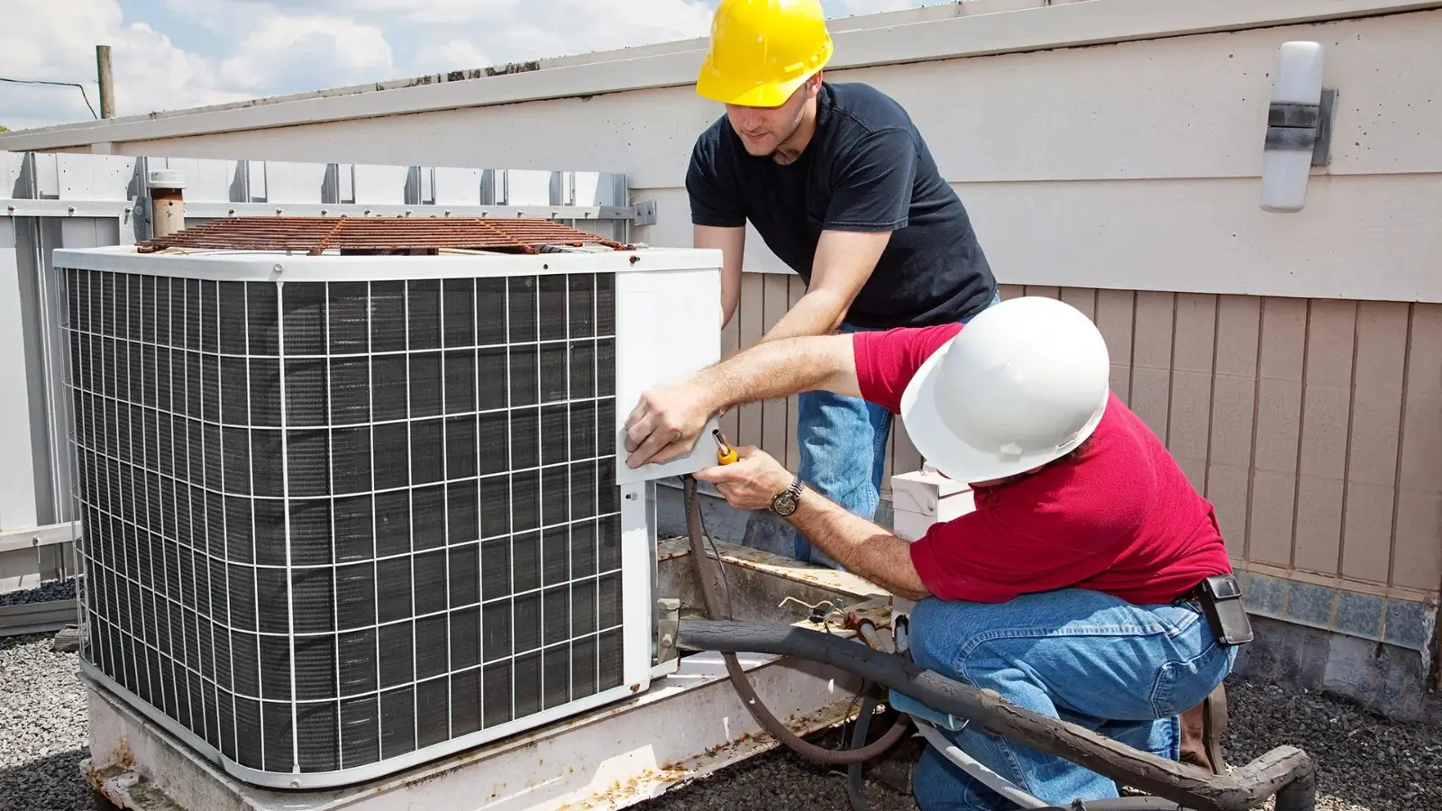 Technician performing routine maintenance on a residential HVAC system