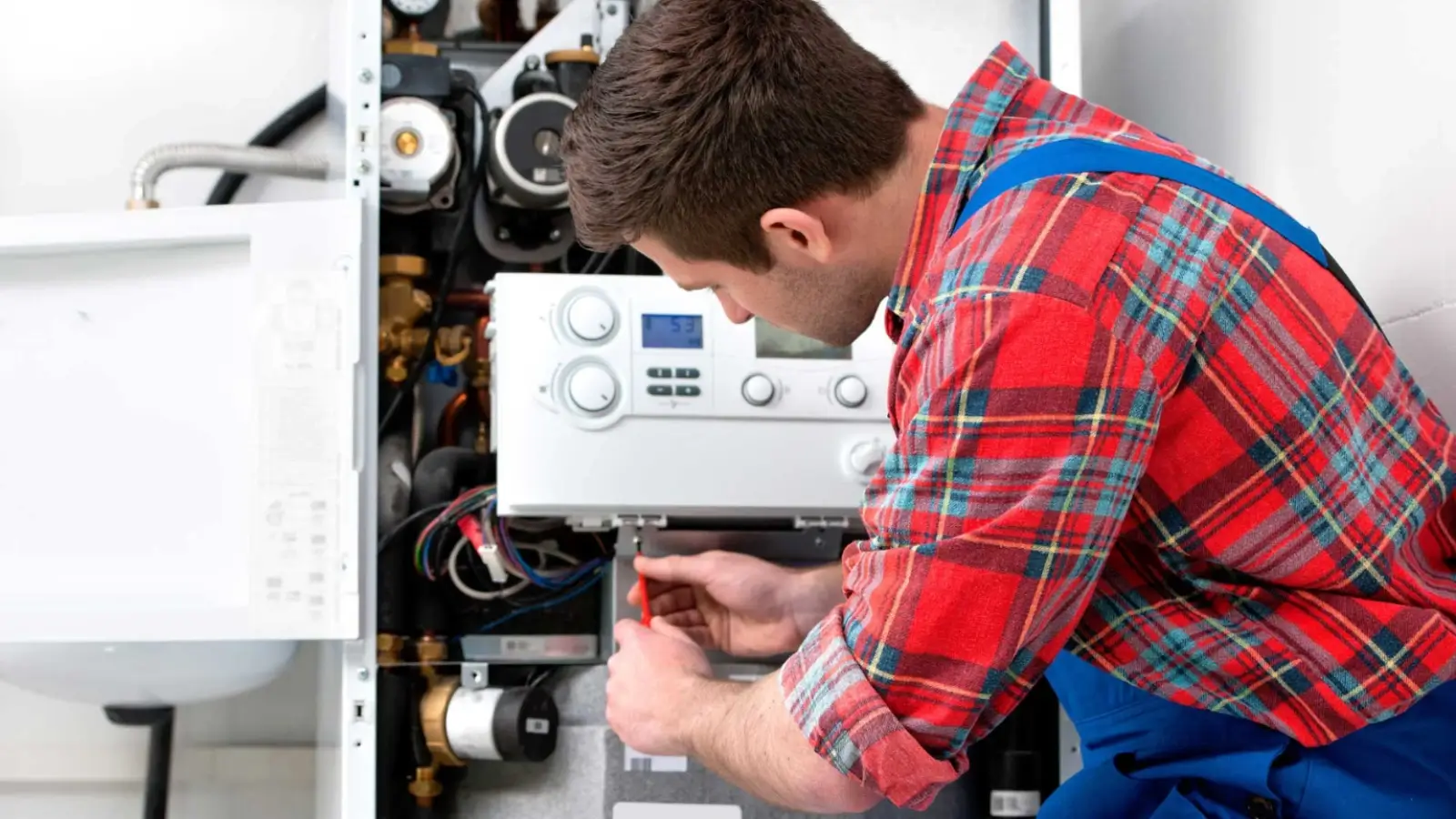 Technician repairing a residential heater in a Phoenix home