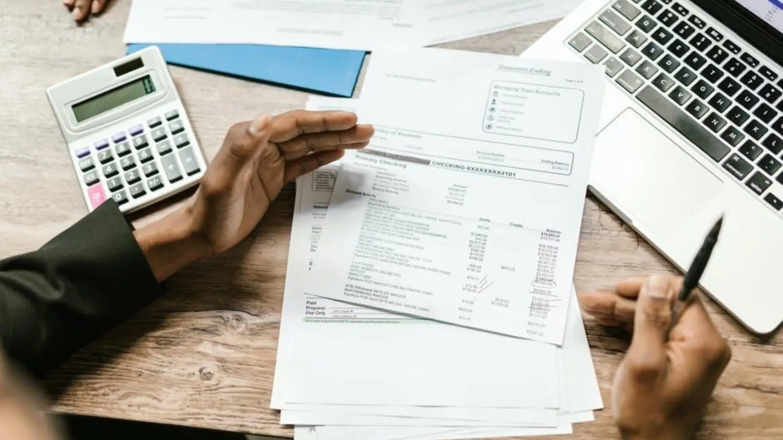 Business owner comparing business checking account features on laptop