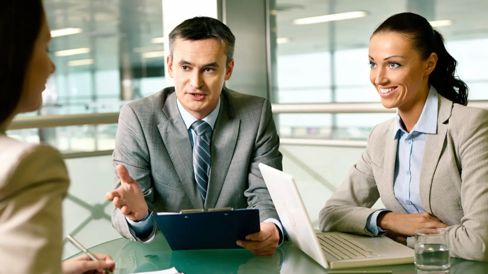 Business owners discussing LLC management structure options at a table