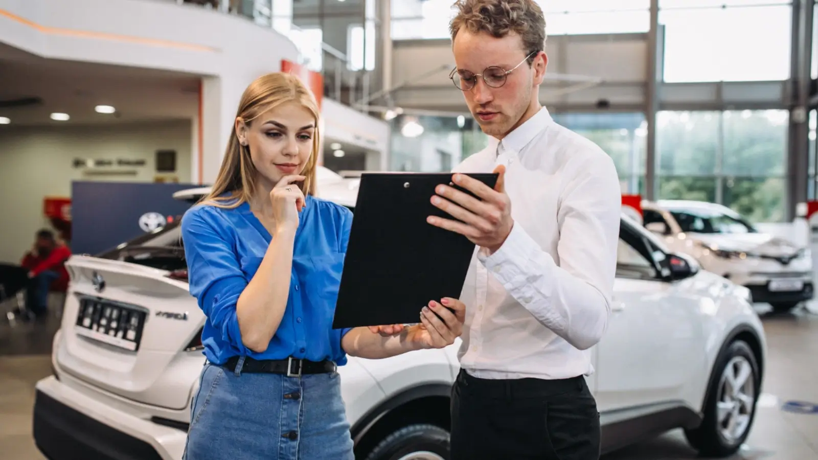 Car buyer inspecting a vehicle at a Findlay dealership using a vehicle checklist