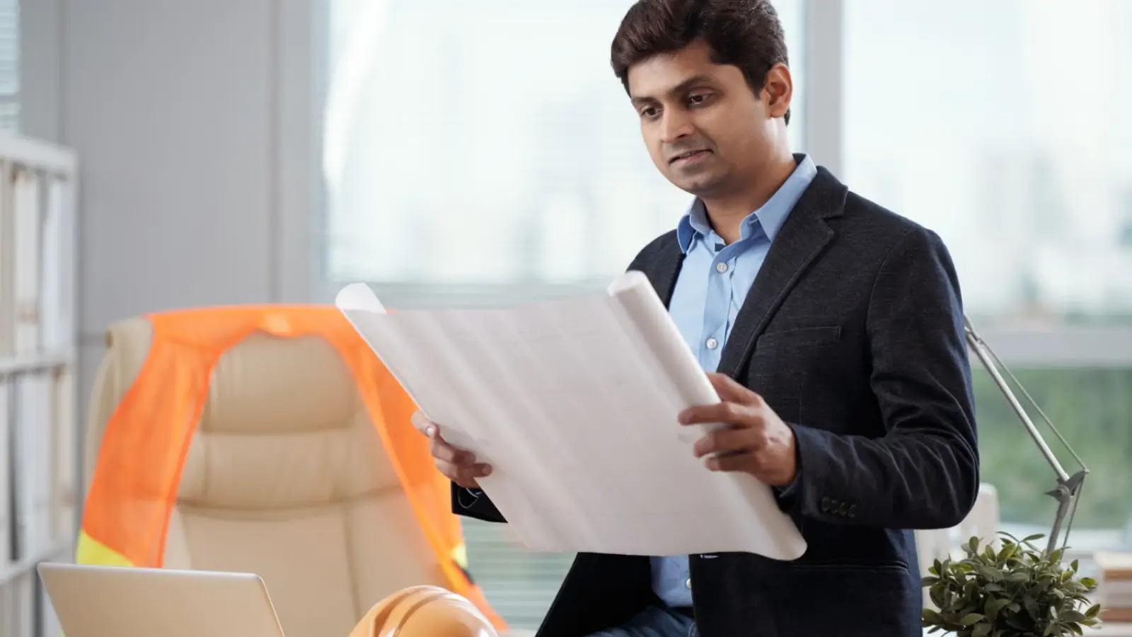 Construction project manager reviewing building permits at a job site