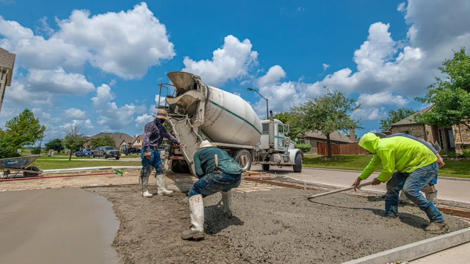 Contractor finishing a freshly poured concrete driveway in Kalamazoo, Michigan
