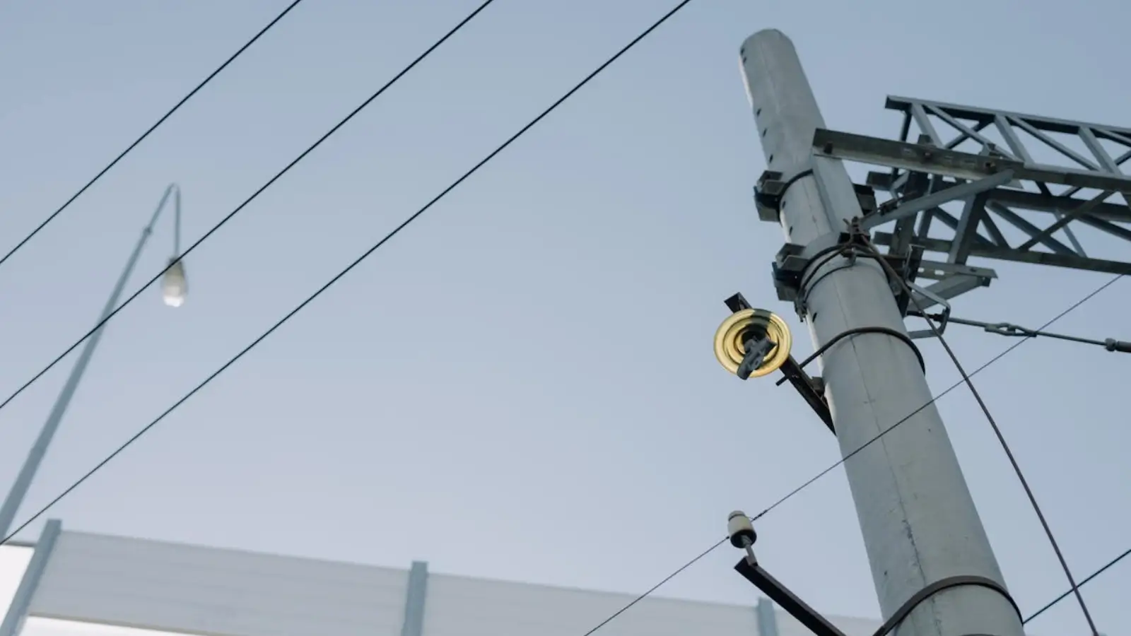 Crew of South Florida pole setters installing utility poles at a commercial construction site