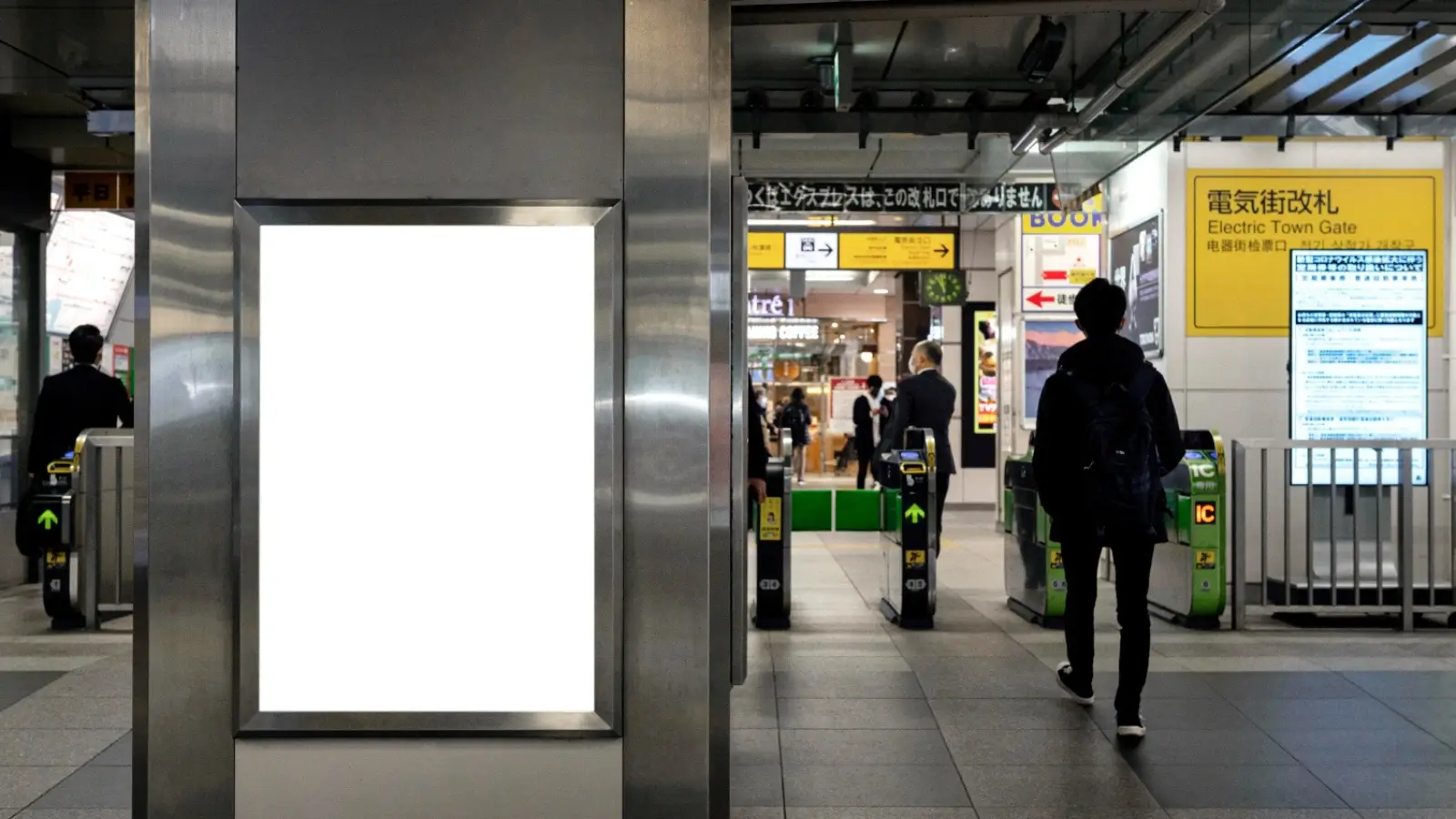 Digital public transport campaign display at a busy urban station