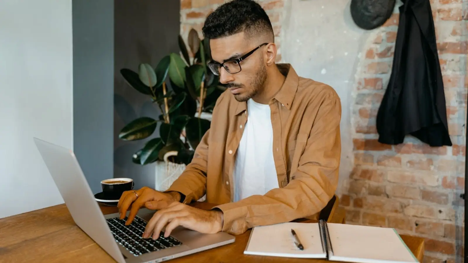 Email developer converting a PSD design into responsive HTML on a laptop