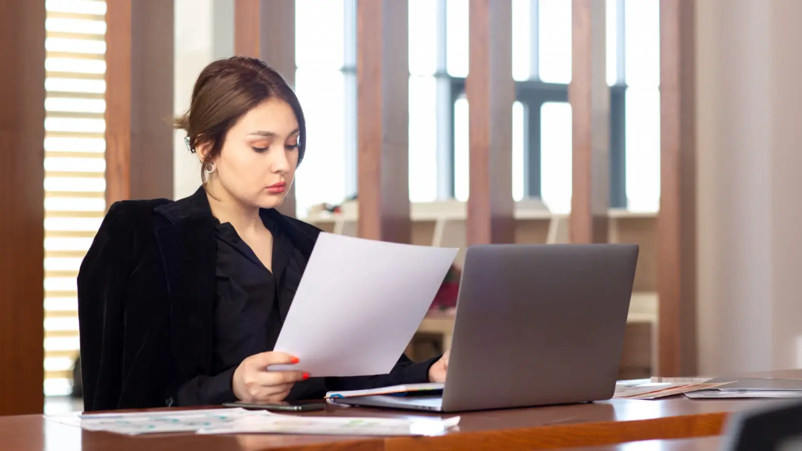 Employer reviewing NDA and confidentiality clause documents in an office setting