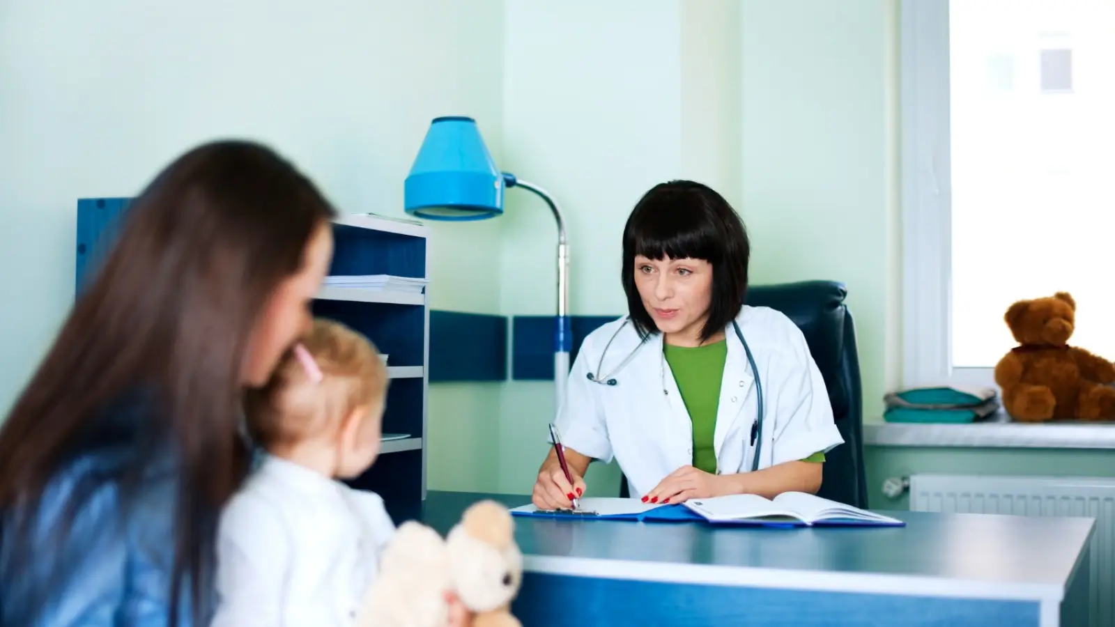 Expat in Thailand reviewing health insurance documents with a Thai hospital in the background