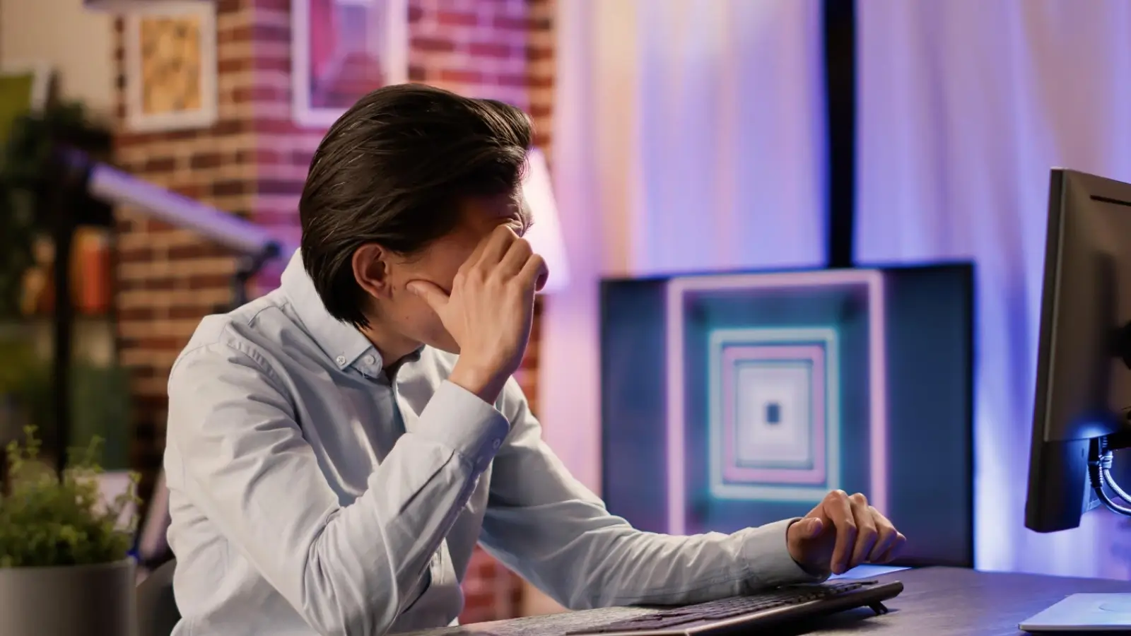 Frustrated business owner reviewing IT bills with server downtime in the background