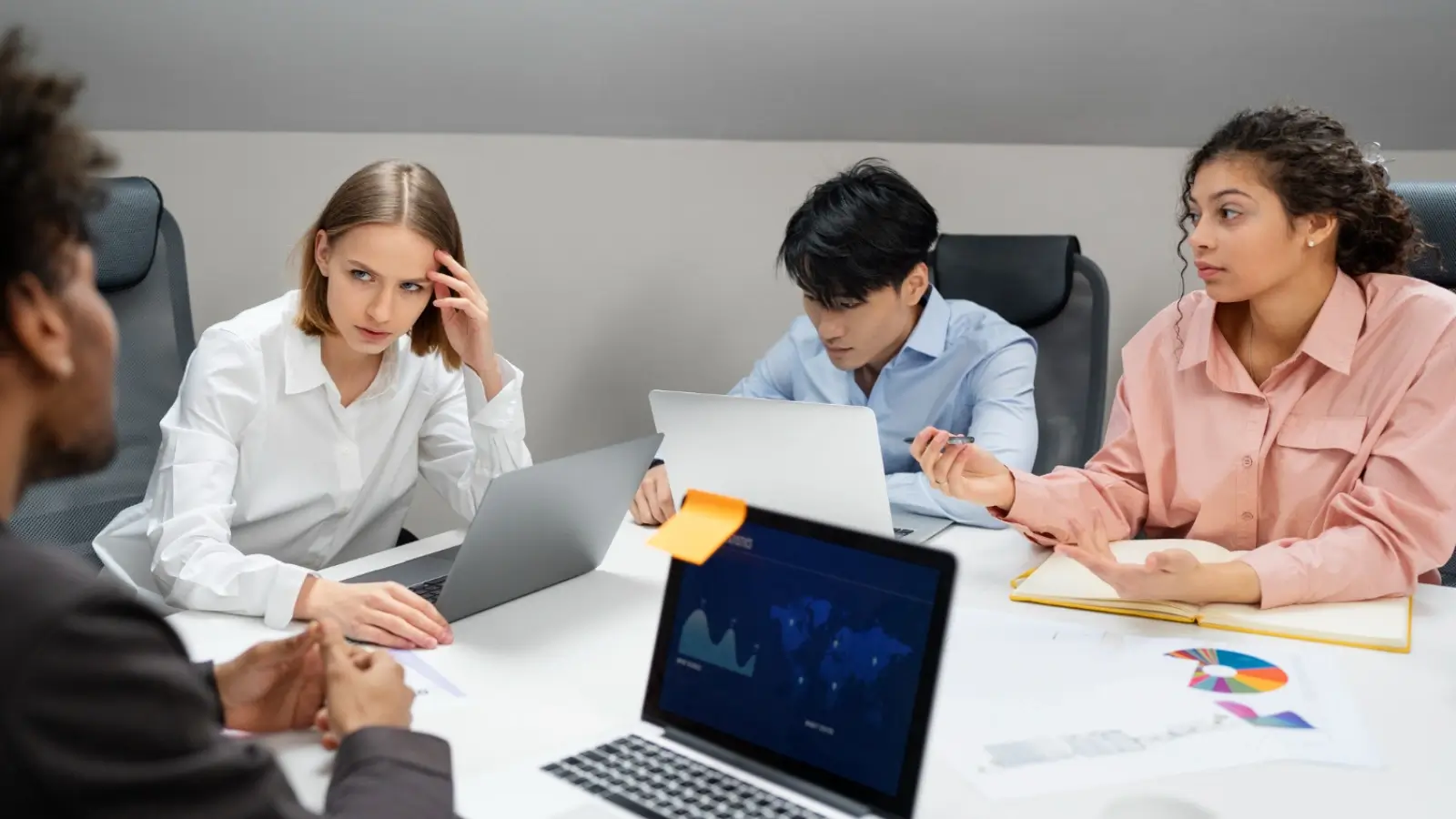 Frustrated marketing team experiencing communication breakdown during a team meeting