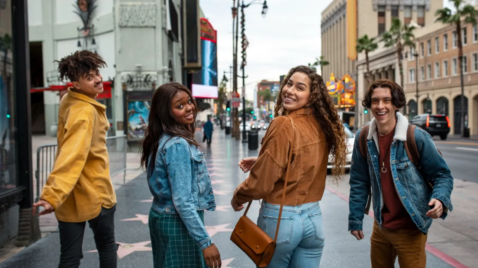 Gen Z travelers walking through a cozy small town with scenic streets and local shops