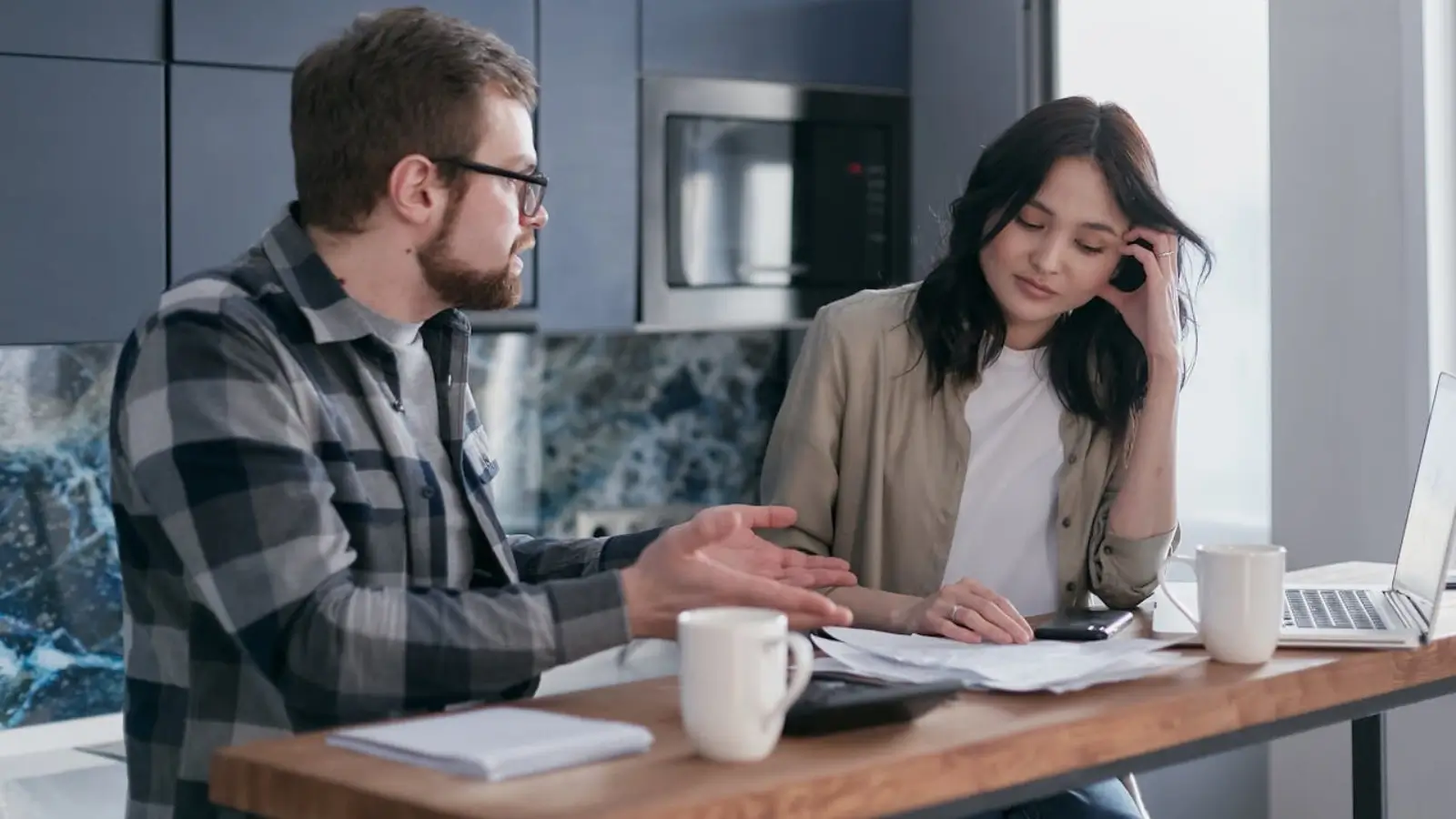 Homeowner planning a renovation budget at the kitchen table