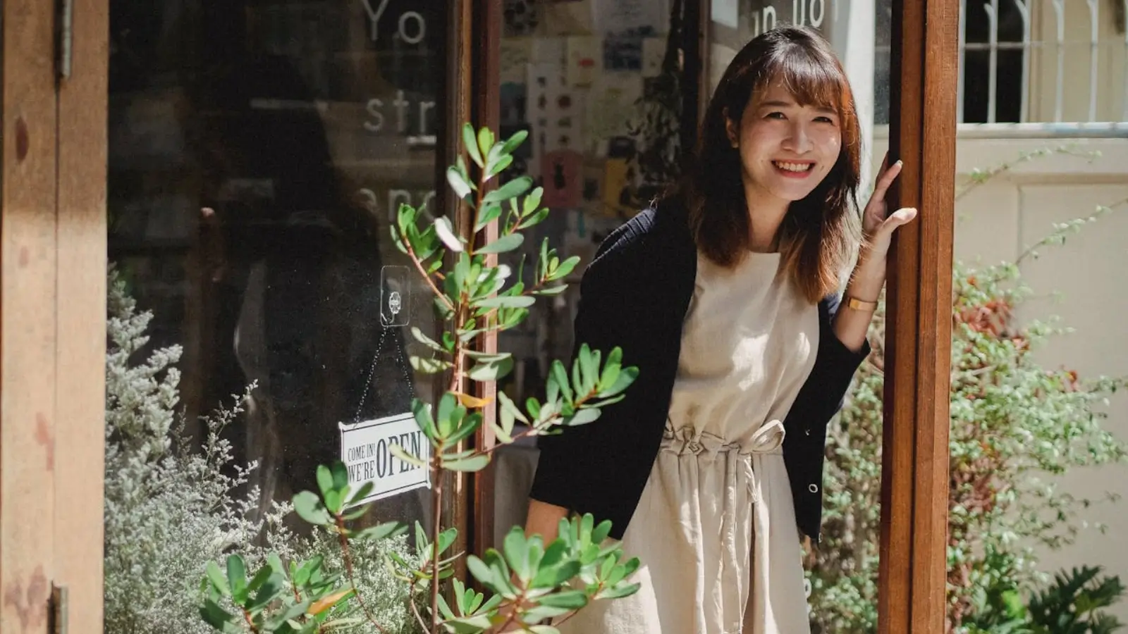 Local business owner welcoming customers with a clean, modern storefront