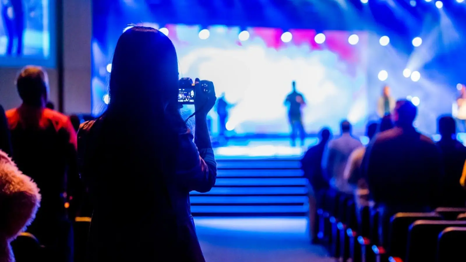 Marketing team promoting a business event through digital and print media