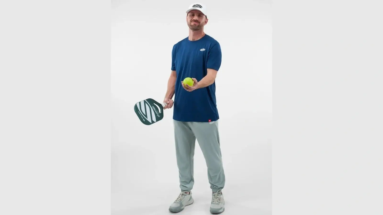 Men’s pickleball player wearing stylish athletic apparel mid-game