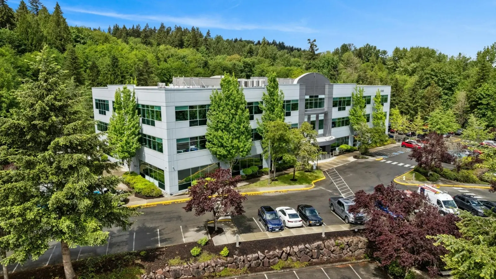 Modern commercial building with newly striped parking lot and landscaped frontage
