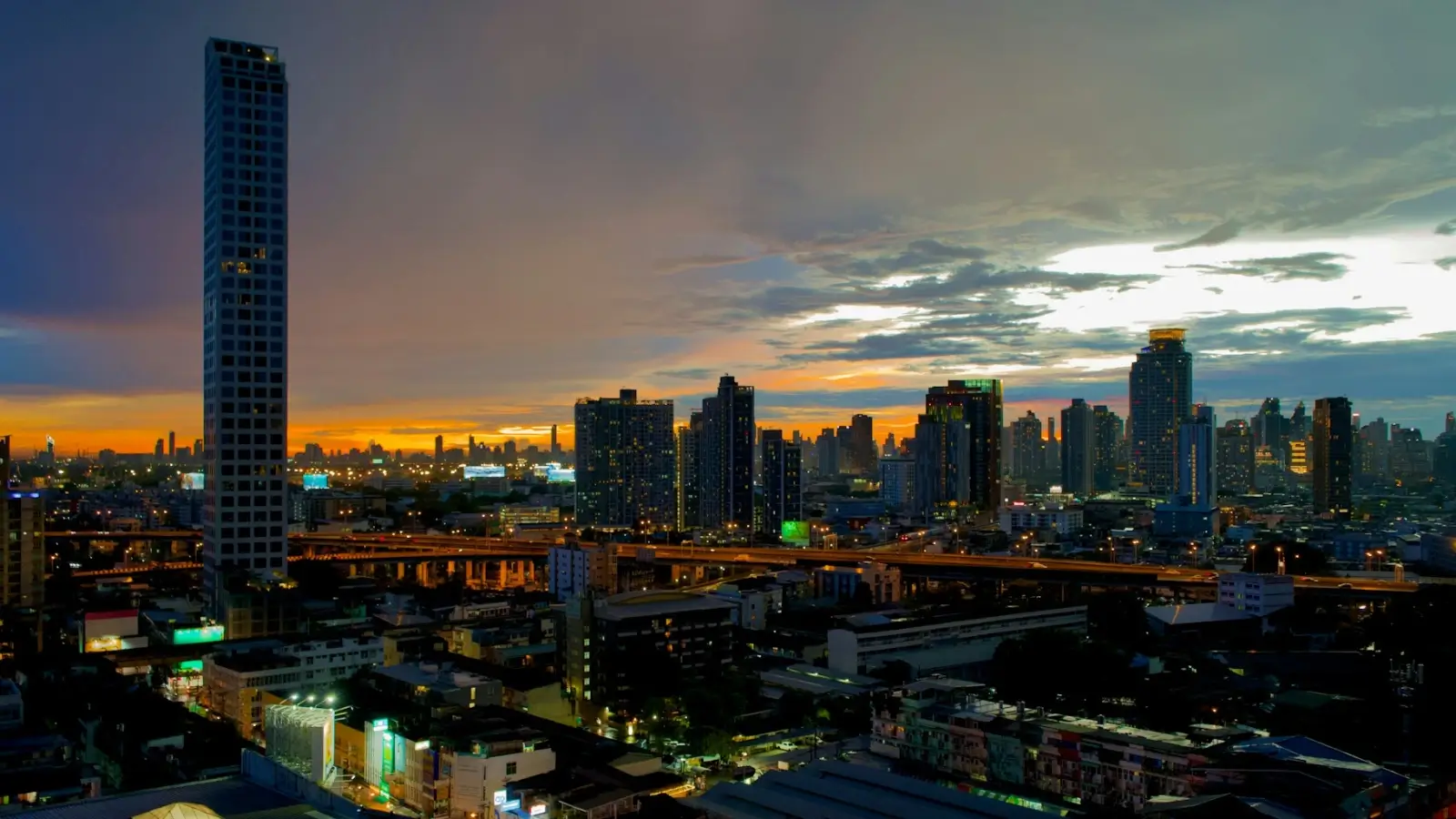 Modern high-rise condominium building in Bangkok at sunset
