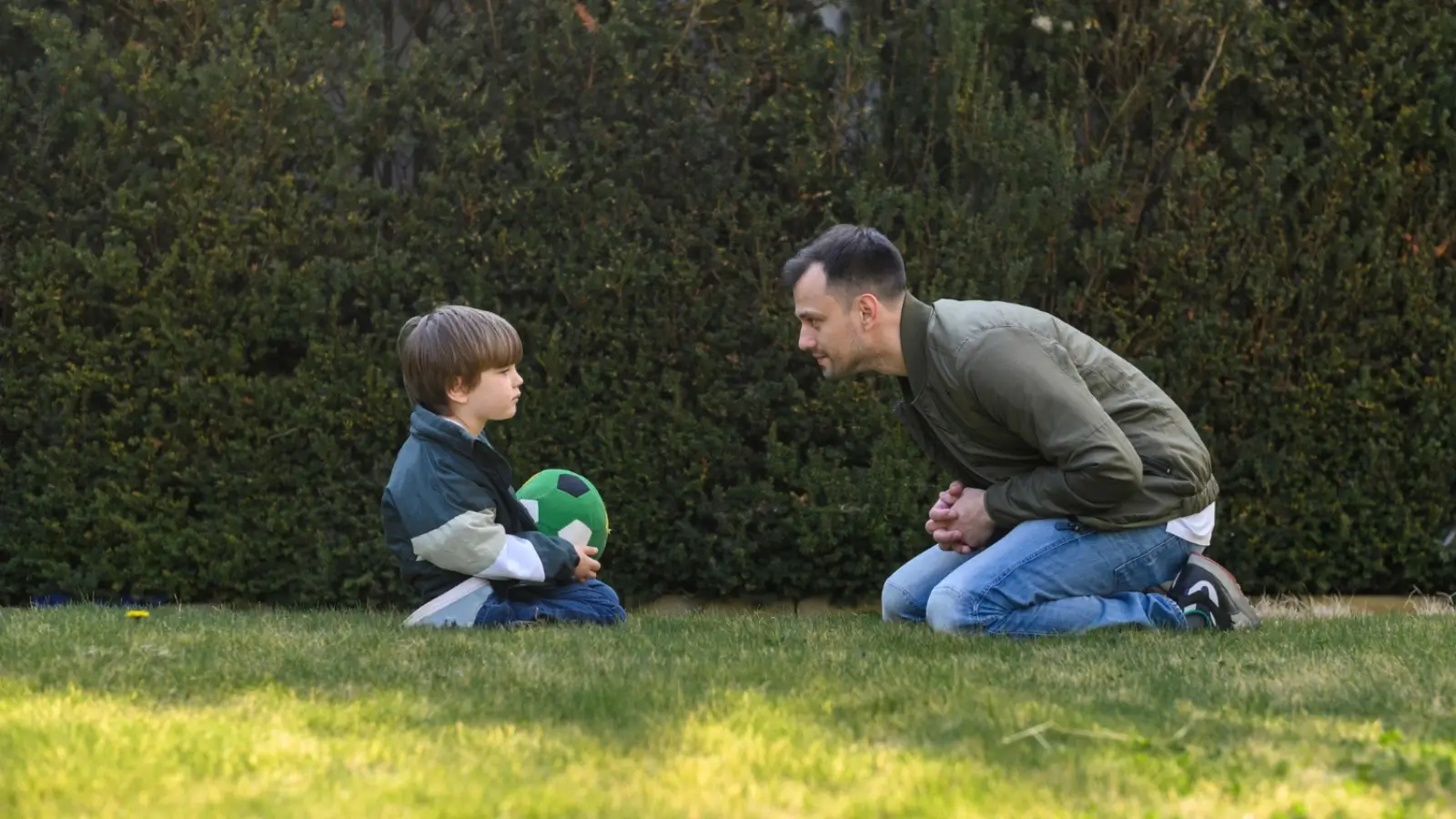 Parent guiding a child with autism at a quiet park during a sensory-friendly outing