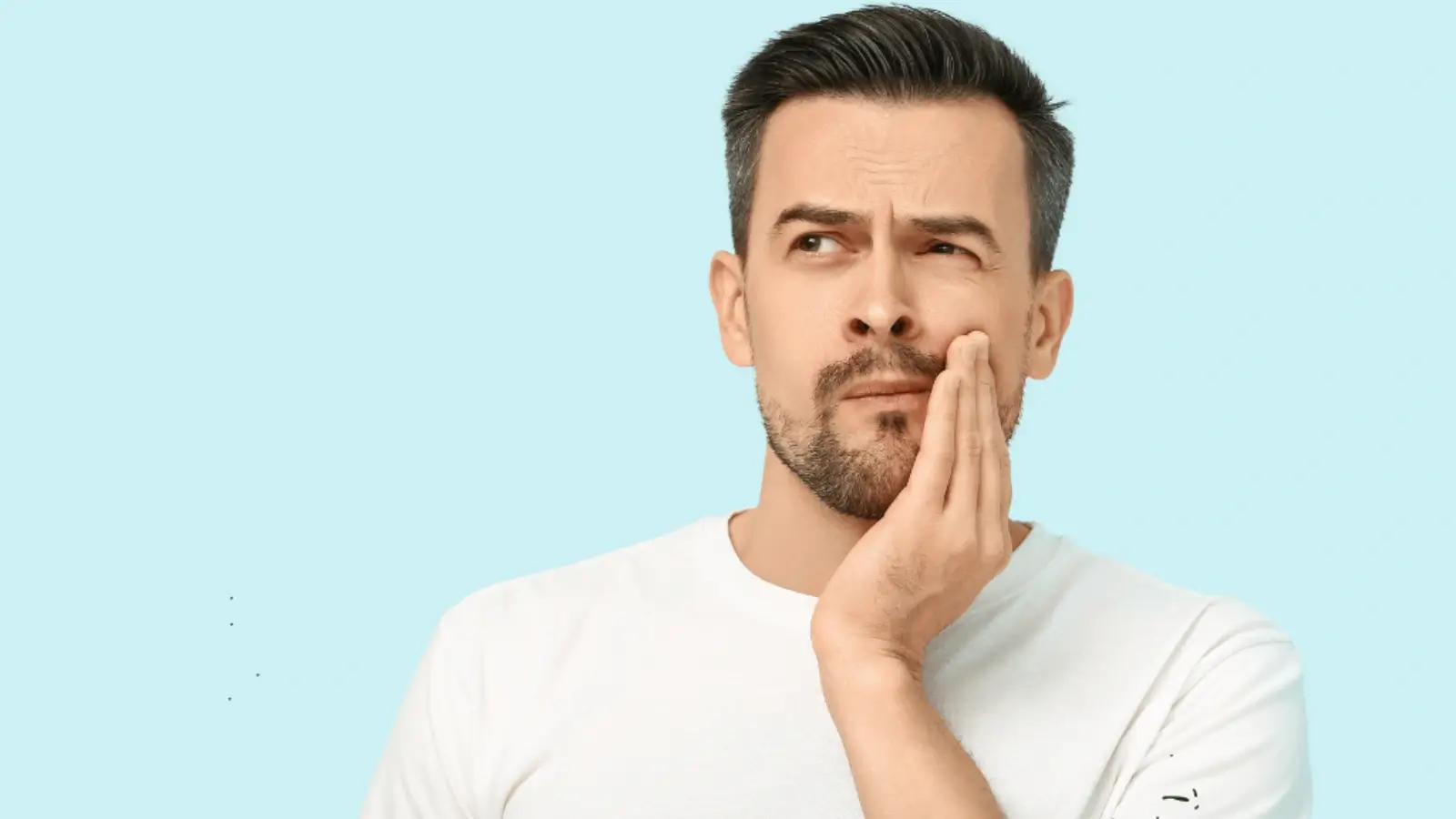 Person brushing teeth in front of a bathroom mirror for oral hygiene