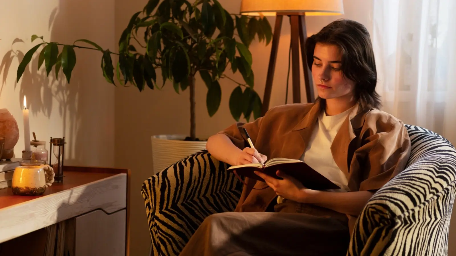 Person journaling in a peaceful home setting, surrounded by recovery tools like water, a light, and therapy notes