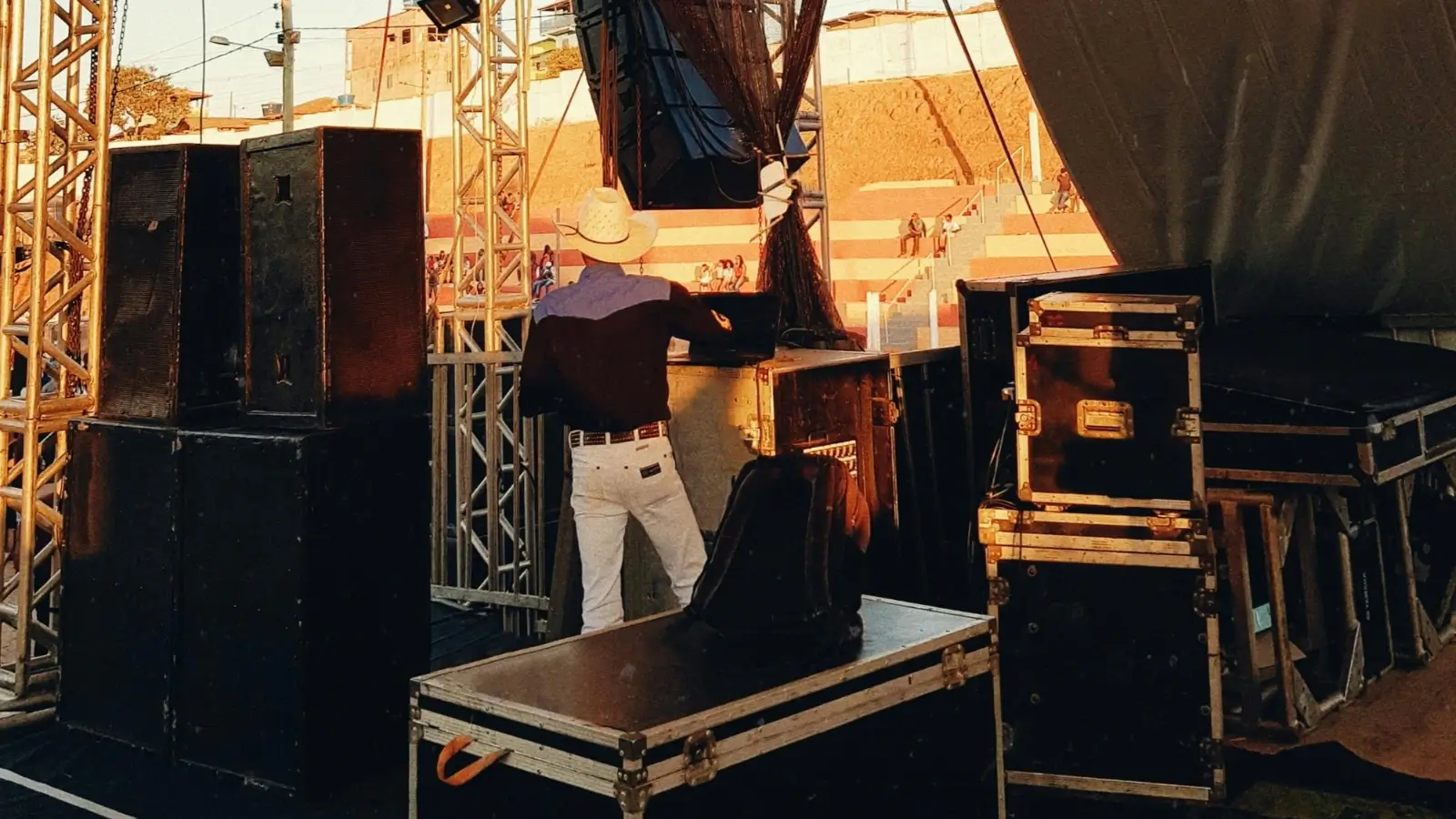 Professional AV crew setting up sound and lighting for a corporate event in a hotel ballroom